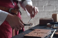 Cleaning of a pewter belt buckle cast in an imprint made in Delft sand